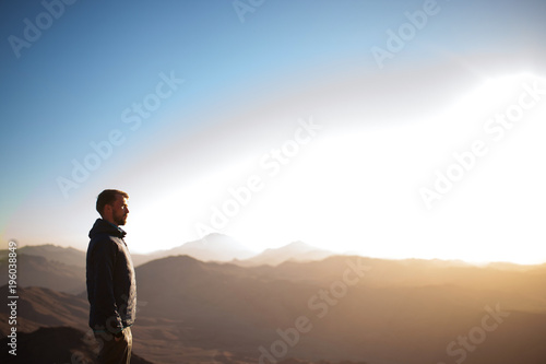 Man stands on Mount Sinai and looks at sunrise. © Stanislav