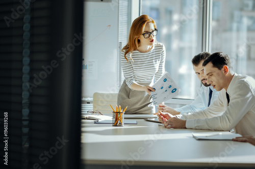 Free Download This is unacceptable. Beautiful young female boss scolding her employees for a poor performance, showing them documents indicating profit loss - GFXLoad