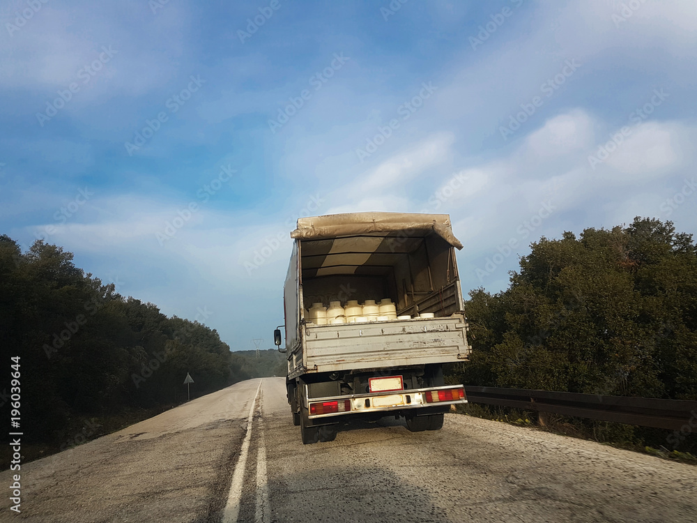 milk trasportation lorry road sky  plastic white can