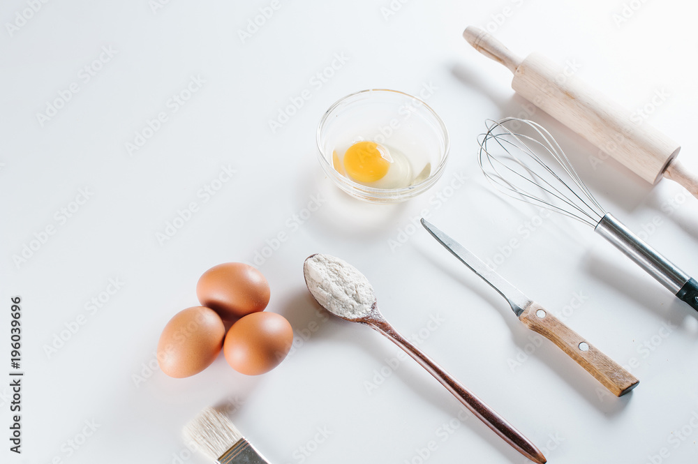 Ingredients for bakery, flour, eggs, yolk, spoon, mixer, rolling pit. Ingredients for bakery, flour, eggs, yolk, spoon, mixer, rolling pit.
