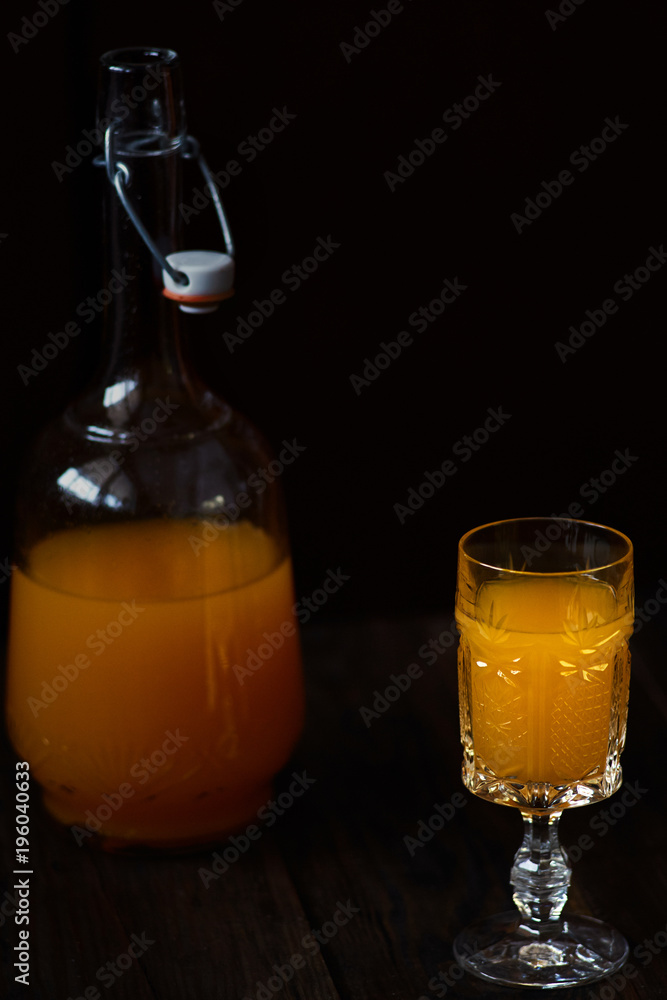 Fresh orange juice in crystal glass with fresh fruits on dark wood table Fresh orange juice in crystal glass with fresh fruits on dark wood table