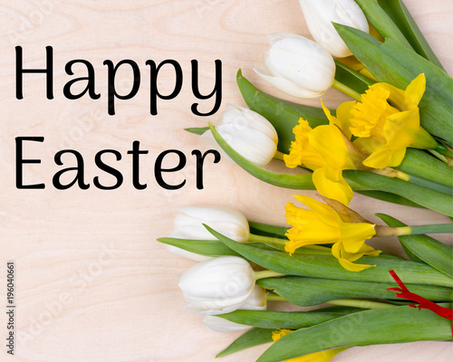  happy easter with fresh flowers, on a natural wooden background