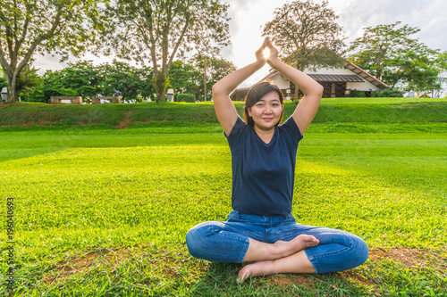 Beautiful young asian woman yoga in the park.