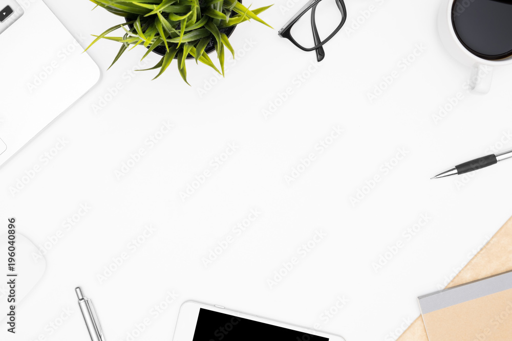 Fototapeta premium White office desk table with laptop, cup of coffee and supplies. Top view with copy space, flay lay.
