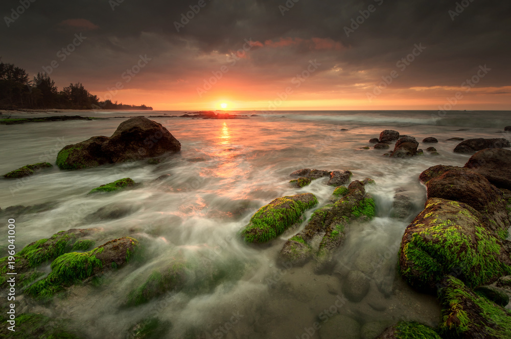 Obraz premium view of seascape during sunset with waves trails.