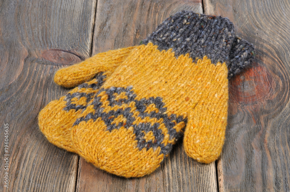 Yellow mittens are handmade. Front view. Stock Photo Adobe Stock
