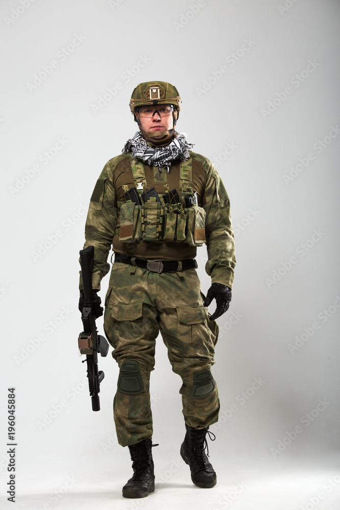 Full-length picture of soldier with gun in his hand Full-length picture of soldier with gun in his hand