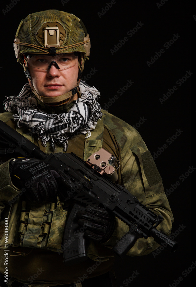 Photo of soldier in safety glasses with gun Photo of soldier in safety glasses with gun
