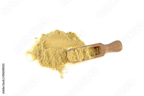 ginger ground on a wooden spoon on a white background