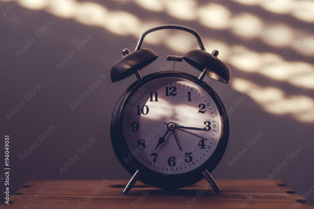 Alarm clock on night table in bedroom Alarm clock on night table in bedroom