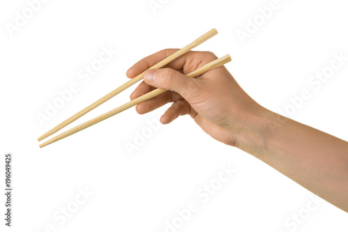 Japanese wooden sticks in female hand isolated on white