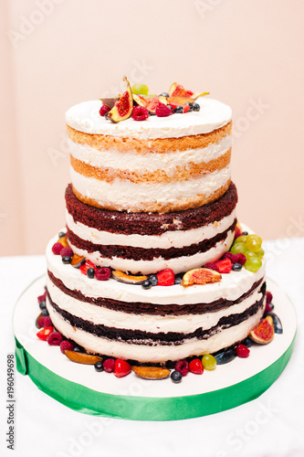 Wedding cake decorated with raspberries and figs