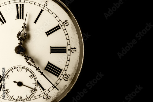 Monochromatic close-up on a old watch with clipped black background and copy space