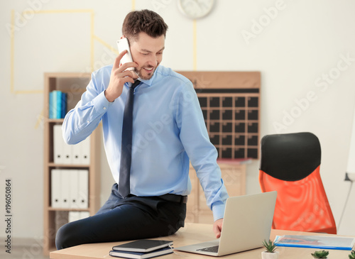 Young man talking on phone ...