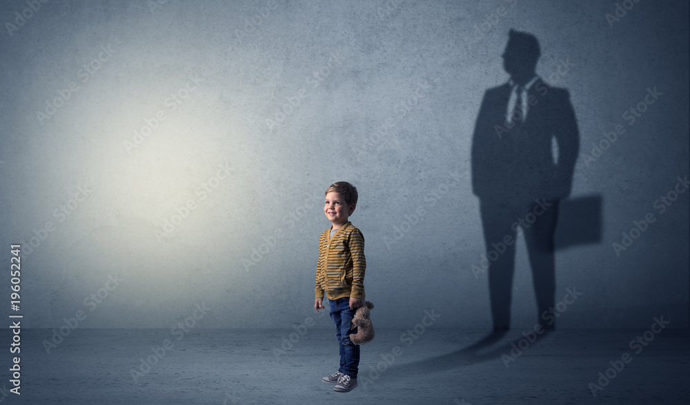 Little boy with businessman shadow Little boy with businessman shadow