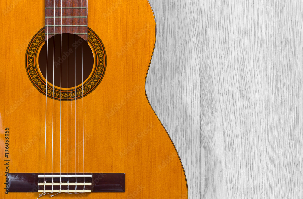 Fototapeta premium Classical Guitar over a Wooden Texture