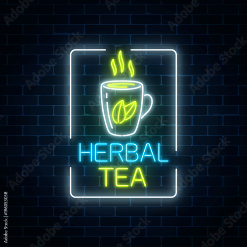 Glowing neon cup of herbal tea sign in rectangle frame on dark brick wall background. Healthy lifestyle concept.