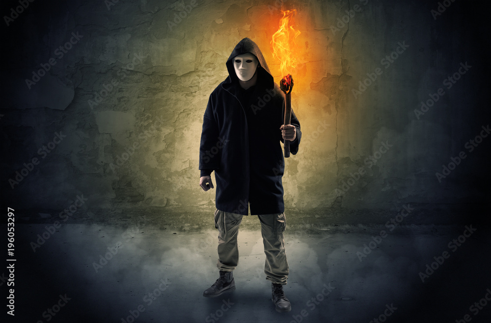 Wayfarer with burning torch in front of crumbly wall concept Wayfarer with burning torch in front of crumbly wall concept