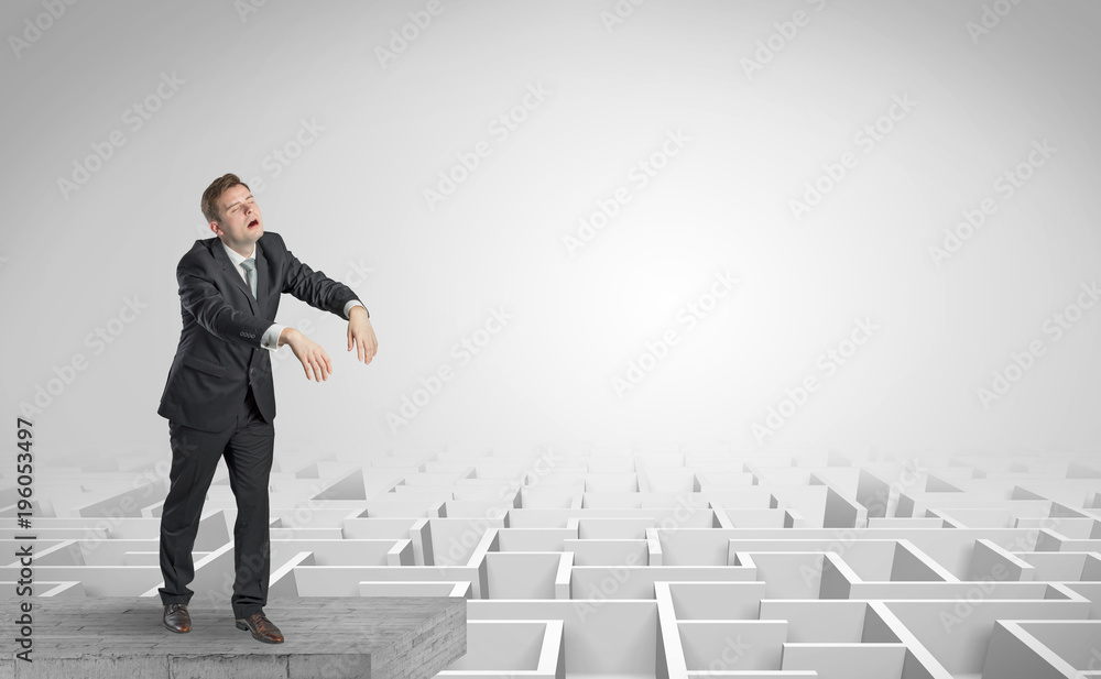 Sleepy businessman on the top of a labyrinth