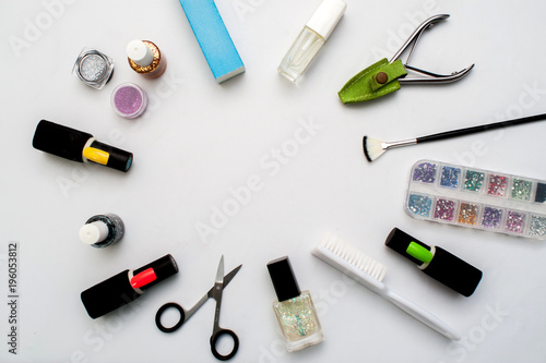 Bottles of nail polish on a colorful wooden table