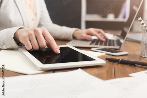 Woman pointing on digital tablet close up