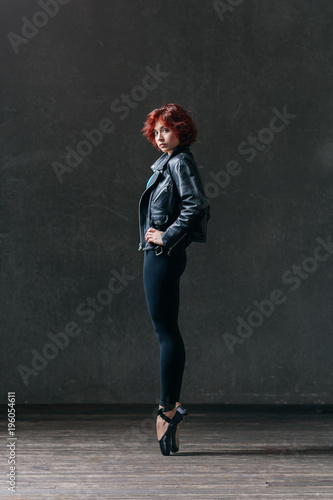 Young beautiful ballerina posing in studio