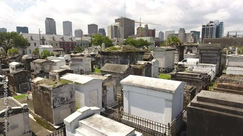 Downtown Skyline and Crane Beyond Old And Urban New Orleans Cemetery photo