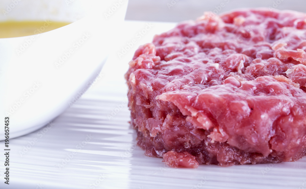 Raw meat over white plate Raw meat over white plate