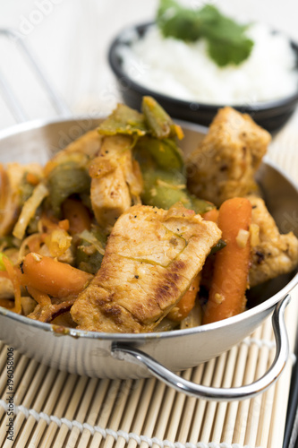 Roast fried meat in a stainless steel pan with rice and vegetables