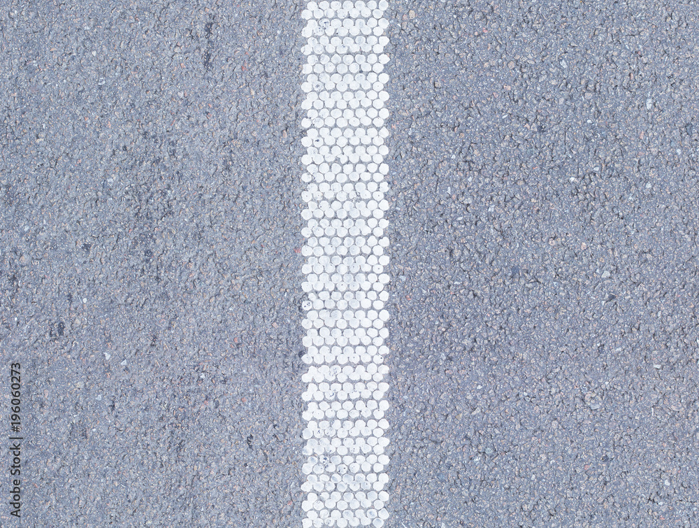 Foto de Texture of dry asphalt with white road markings, vertical tile