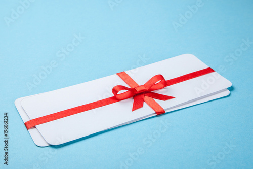 Air tickets as a gift with a red ribbon and bow.