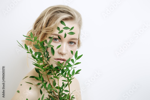 woman with green leaves