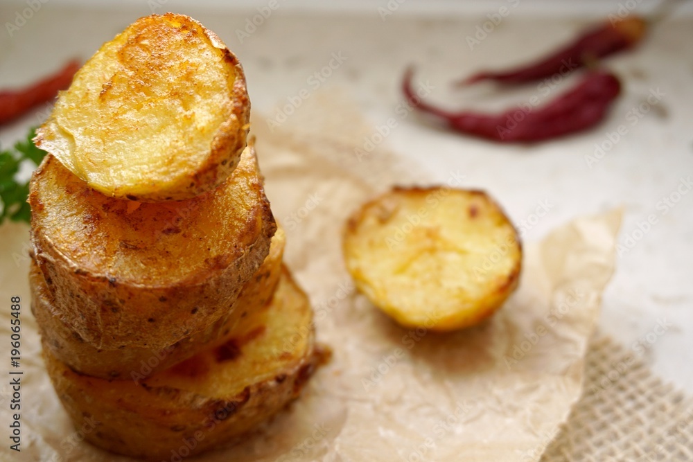 baked potatoes as a tower. put together on the baking paper. With parsley and chilli baked potatoes as a tower. put together on the baking paper. With parsley and chilli