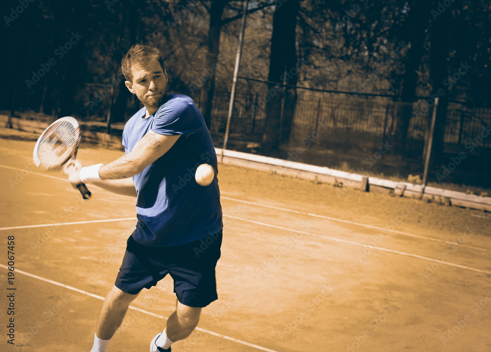 Tennis, player strong punches the ball with a racket Tennis, player strong punches the ball with a racket