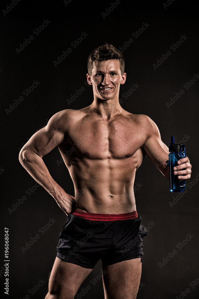 Sportsman with drinking water, fit torso, body