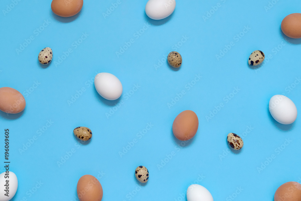 Hen white and brown eggs and quail eggs on blue background, copy space. Healthy food concept. Top view, flat lay. Easter eggs. Happy Easter concept Hen white and brown eggs and quail eggs on blue background, copy space. Healthy food concept. Top view, flat lay. Easter eggs. Happy Easter concept