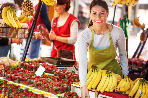 Fotografija Portrait of young saleswoman on fruit market .