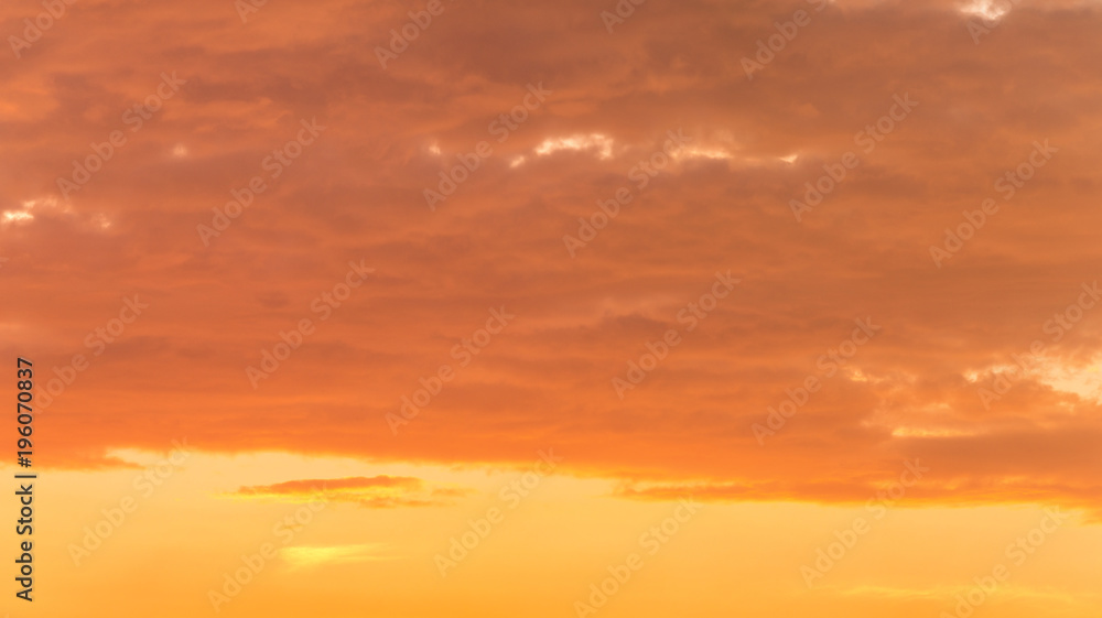 Fiery orange very beautiful sunset sky. Dramatic clouds after rain