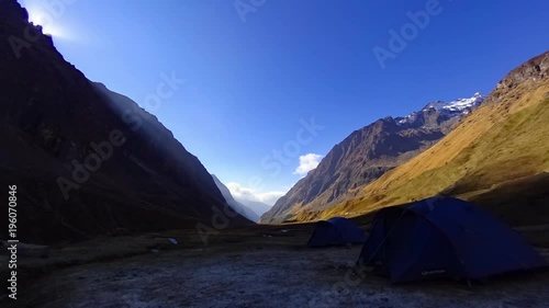 Time lapse of the sunrise and shadow of the mountain taken at the base camp of Pindari Glacier in Himachal Pradesh, India photo