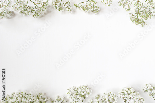 Styled stock photo. Feminine wedding desktop with baby's breath Gypsophila flowers on white background. Empty space. Floral frame, web banner. Top view. Picture for blog or social media. photo