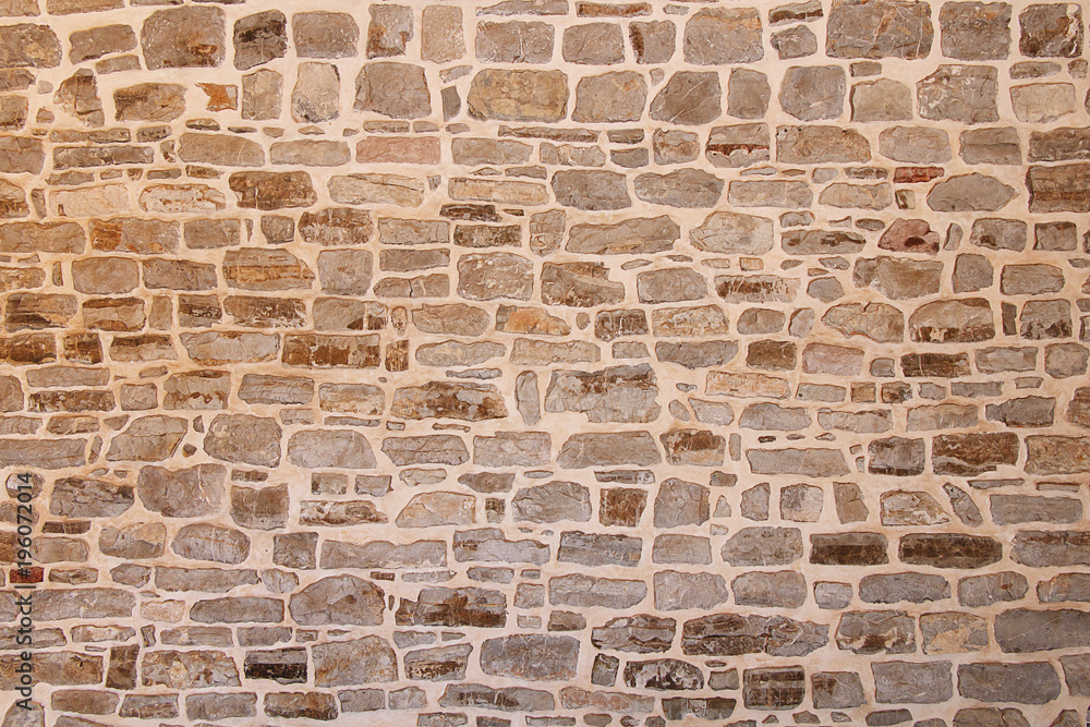 Fototapeta premium Fragment of the stone wall of the old fortress of the city