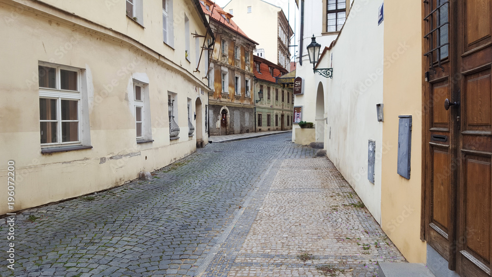 View on the narrow cobblestoned street in Prague, Czech Republic.