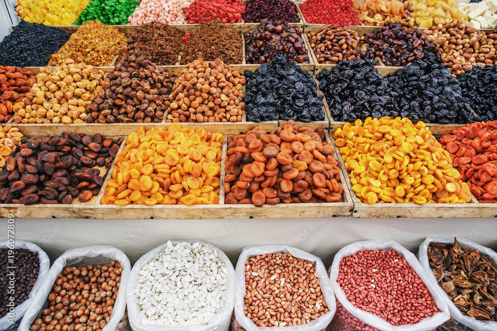 Dried fruits on food market, boxes with colorful assortment of vegetarian healthy dry fruits