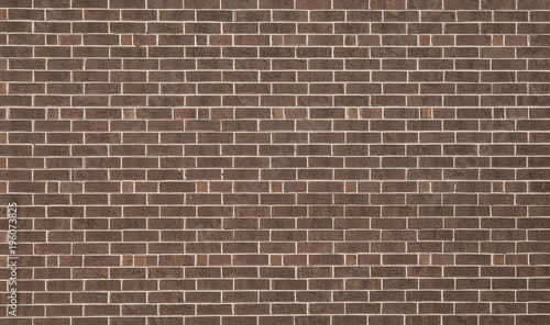 A dark brown brick wall for a textured and patterned background.