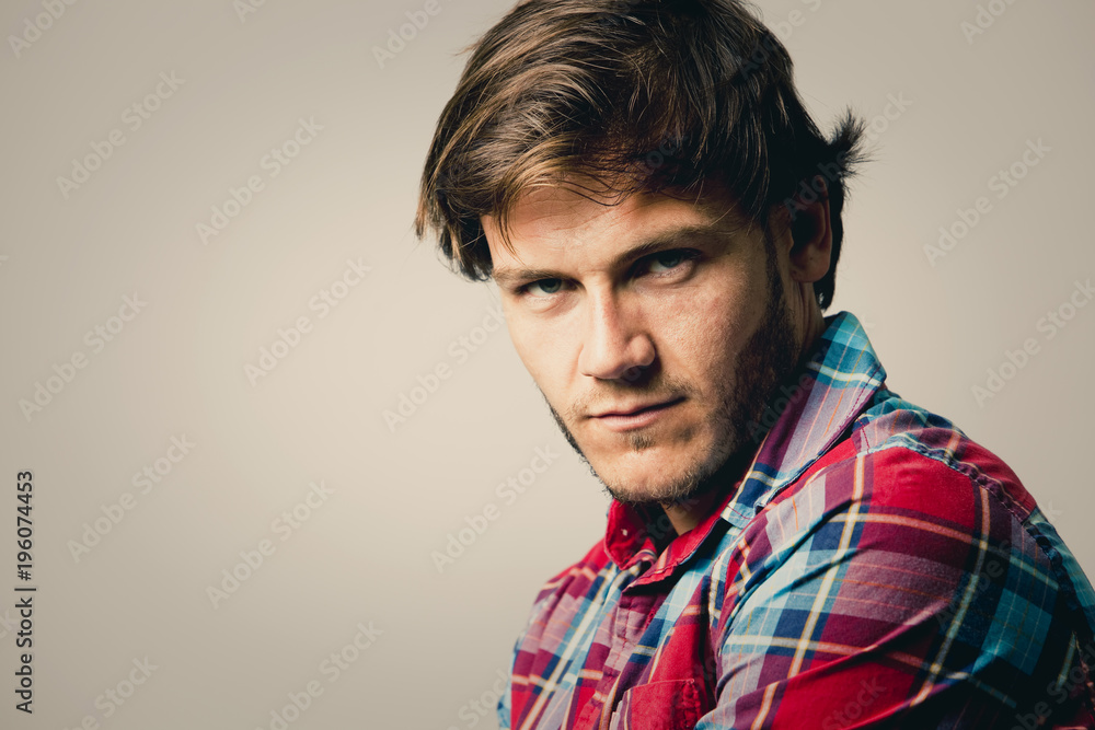 Obraz premium caucasian man wearing checkered shirt and trendy hairstyle