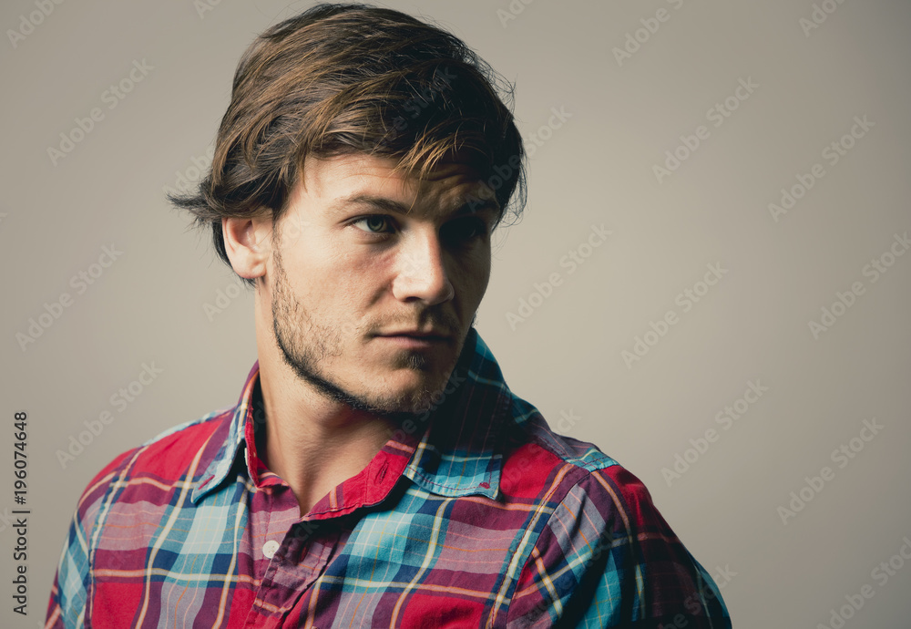 Obraz premium caucasian man wearing checkered shirt and trendy hairstyle
