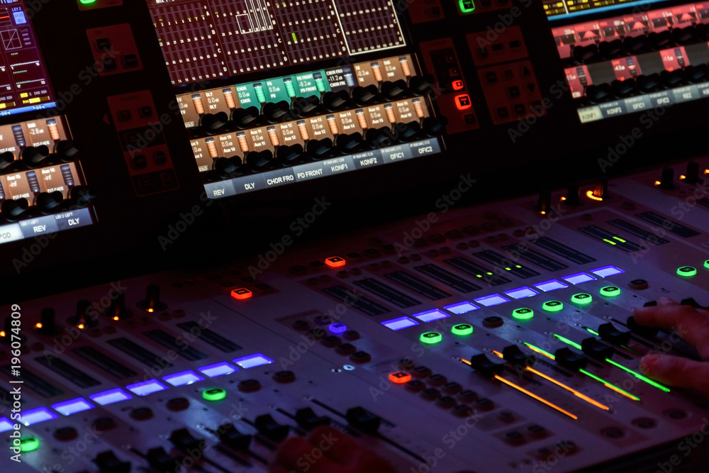Director working on the video or sound mixing console in the studio Director working on the video or sound mixing console in the studio