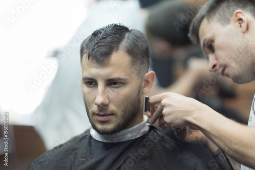 Young handsome man in barbershop