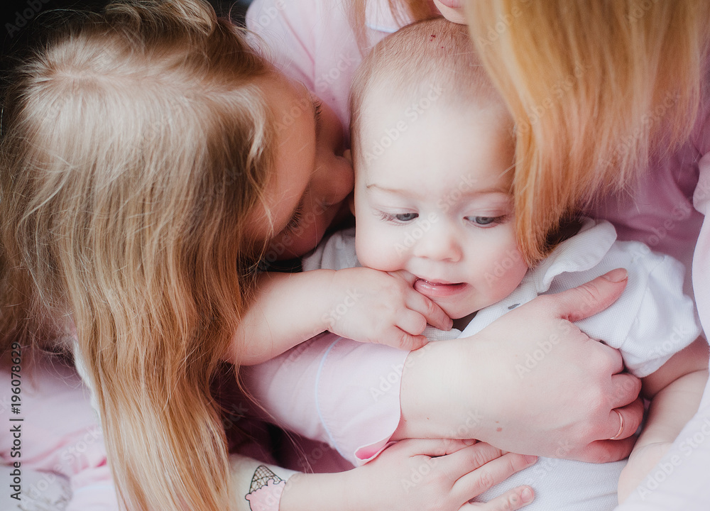 baby kissing sisters and mothers baby kissing sisters and mothers