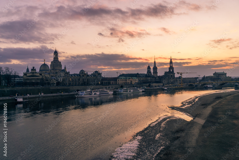 Dresden, Germany old town skyline on the Elbe River at sunset in the winter.